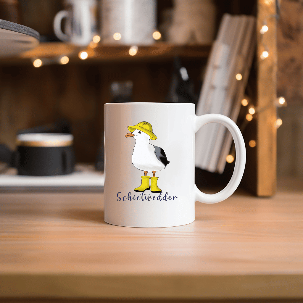 Maritime Kaffeetasse: Möwe im Regenmantel mit Schietwedder-Schriftzug